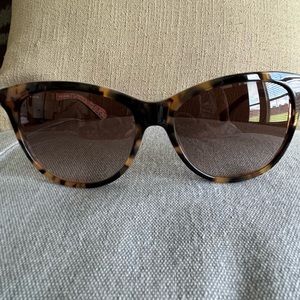 Kate Spade tortoise sunglasses with floral design.